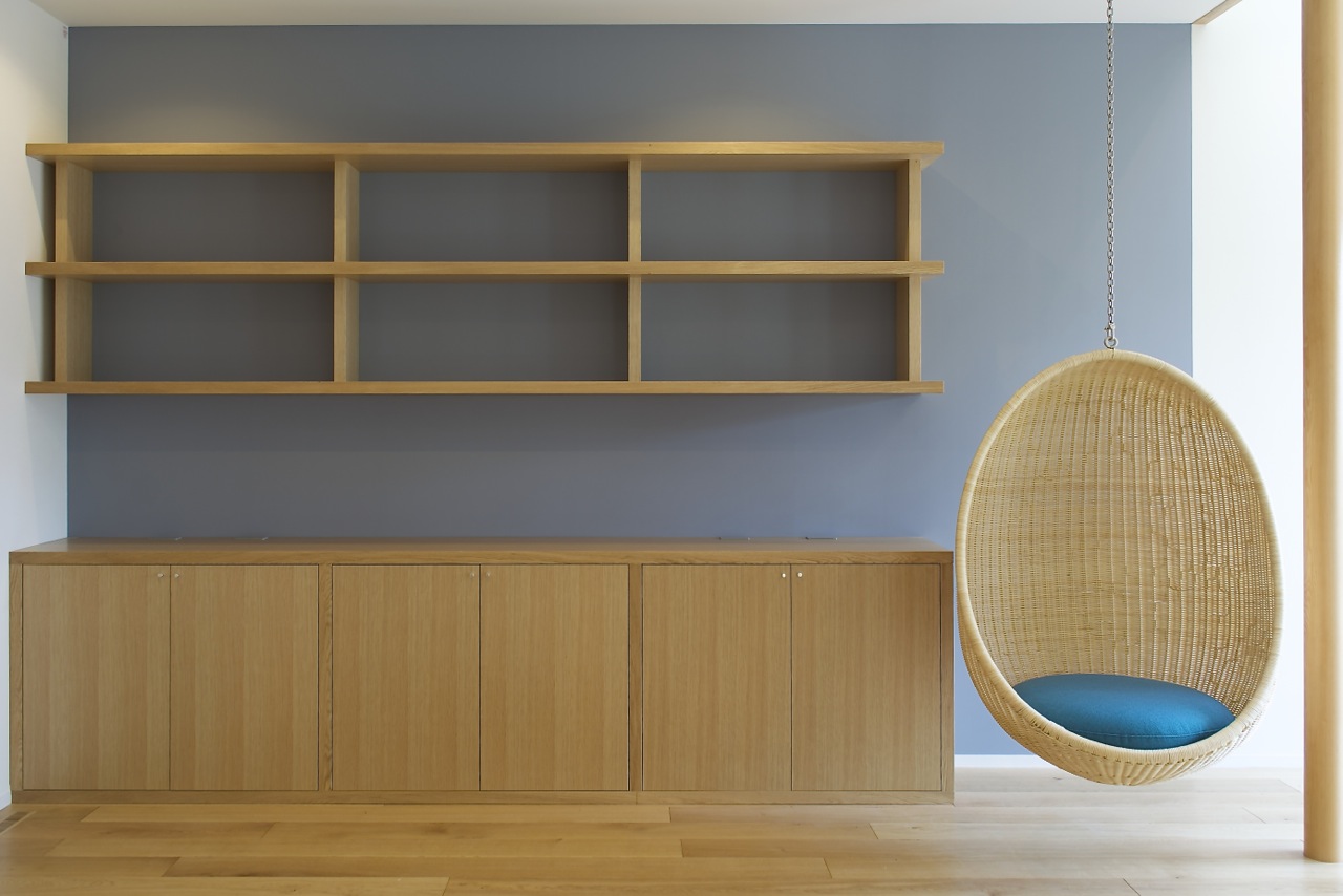 Bookshelves and storage furniture with hanging chair.   Bookshelves and storage furniture with hanging chair.